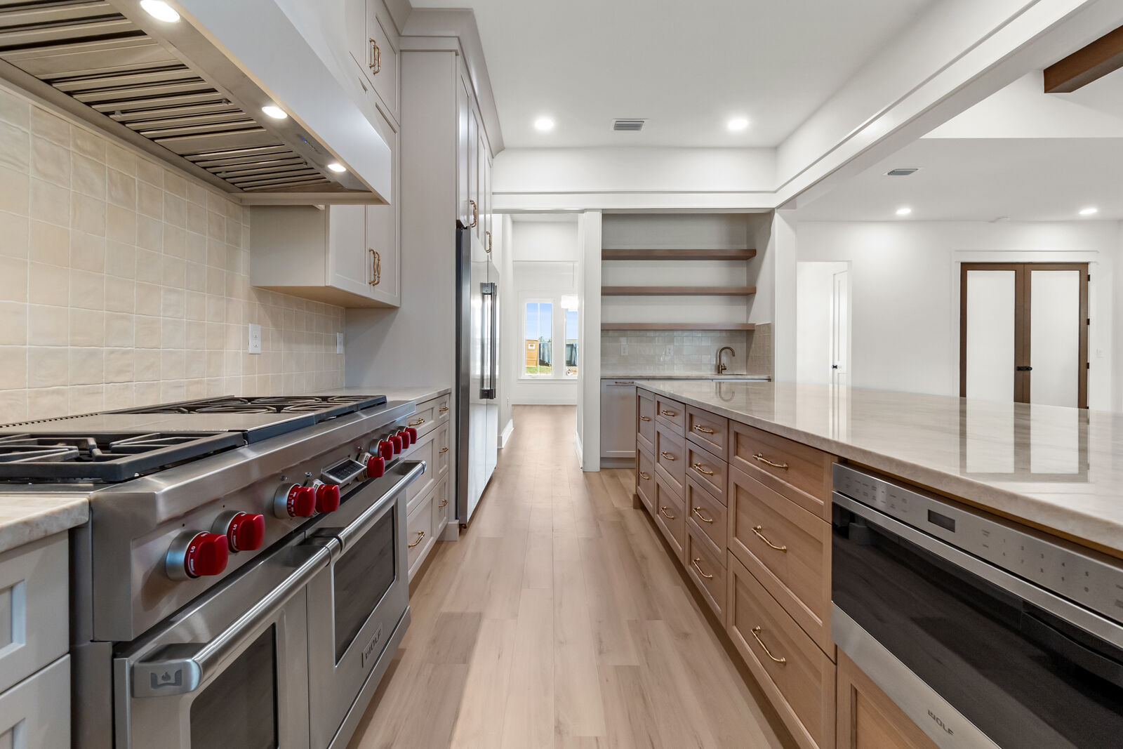 Professional gas range and custom cabinetry in an AJAC Group custom kitchen