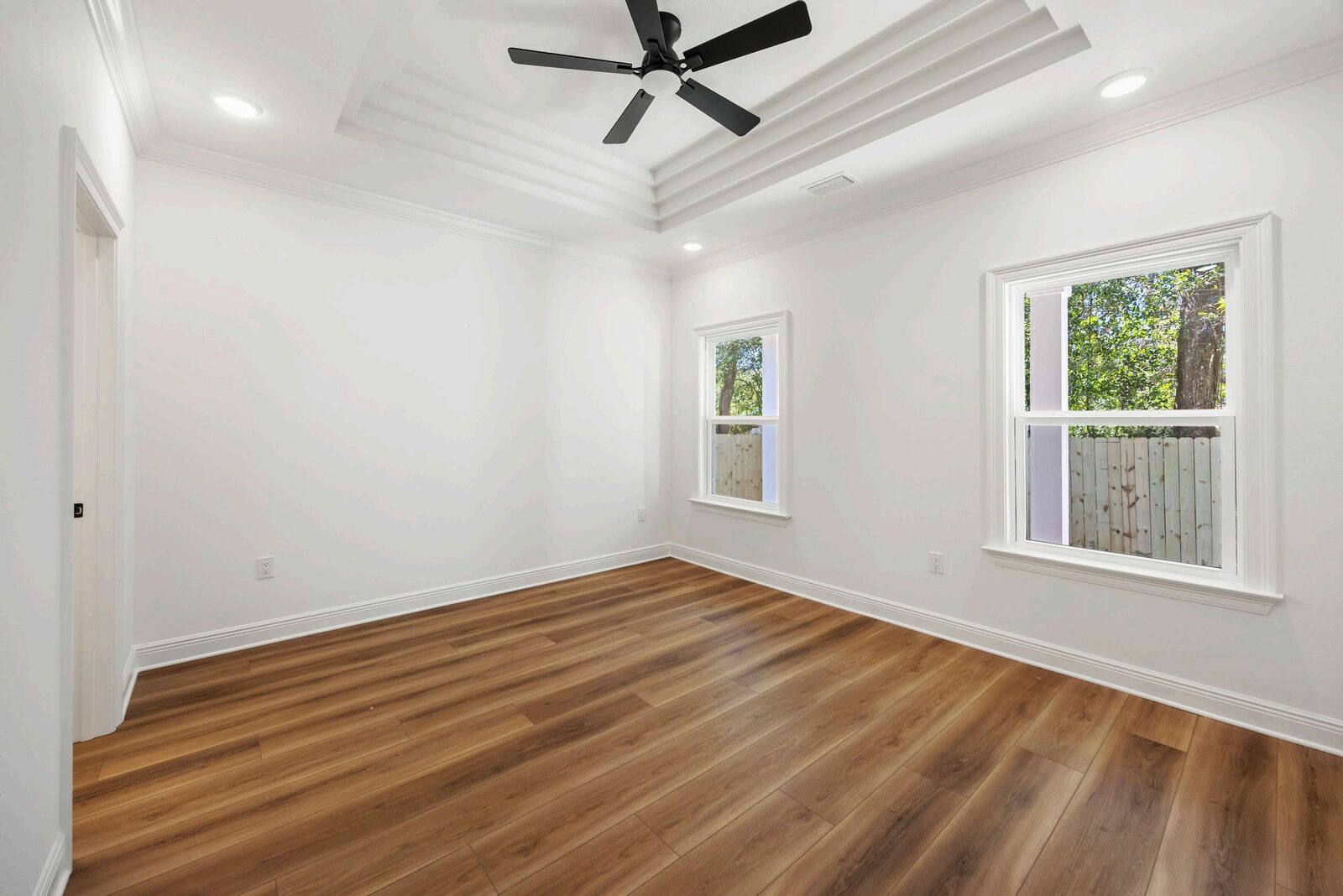 Master bedroom with tray ceiling in an AJAC Group home